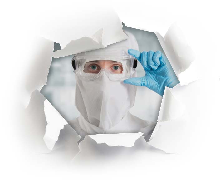 Cleanroom technician in safety goggles, gloves, and mask